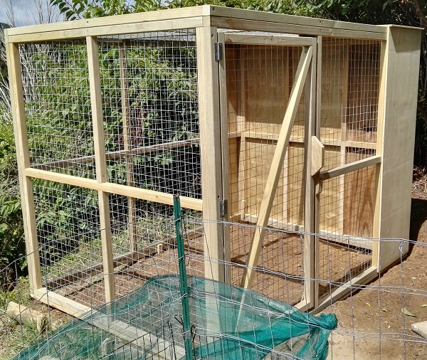 large bird aviary with wooden frame